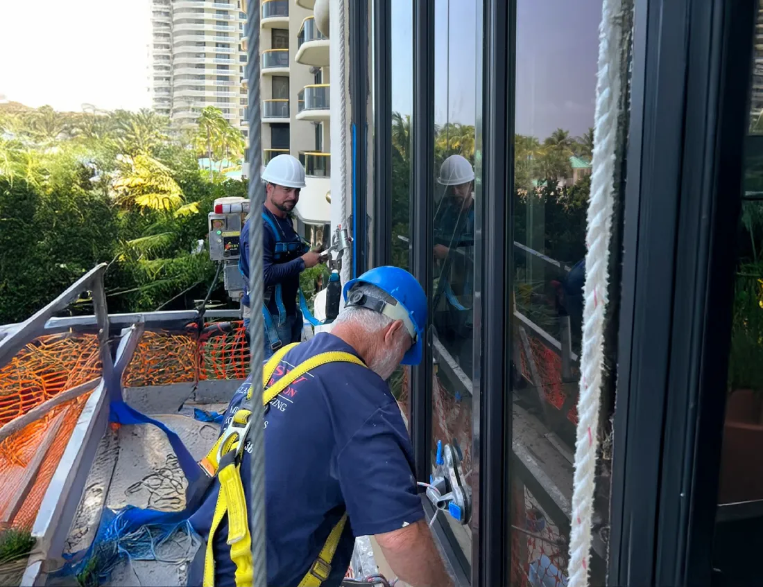TISW installers setting an impact window on a Miami high-rise